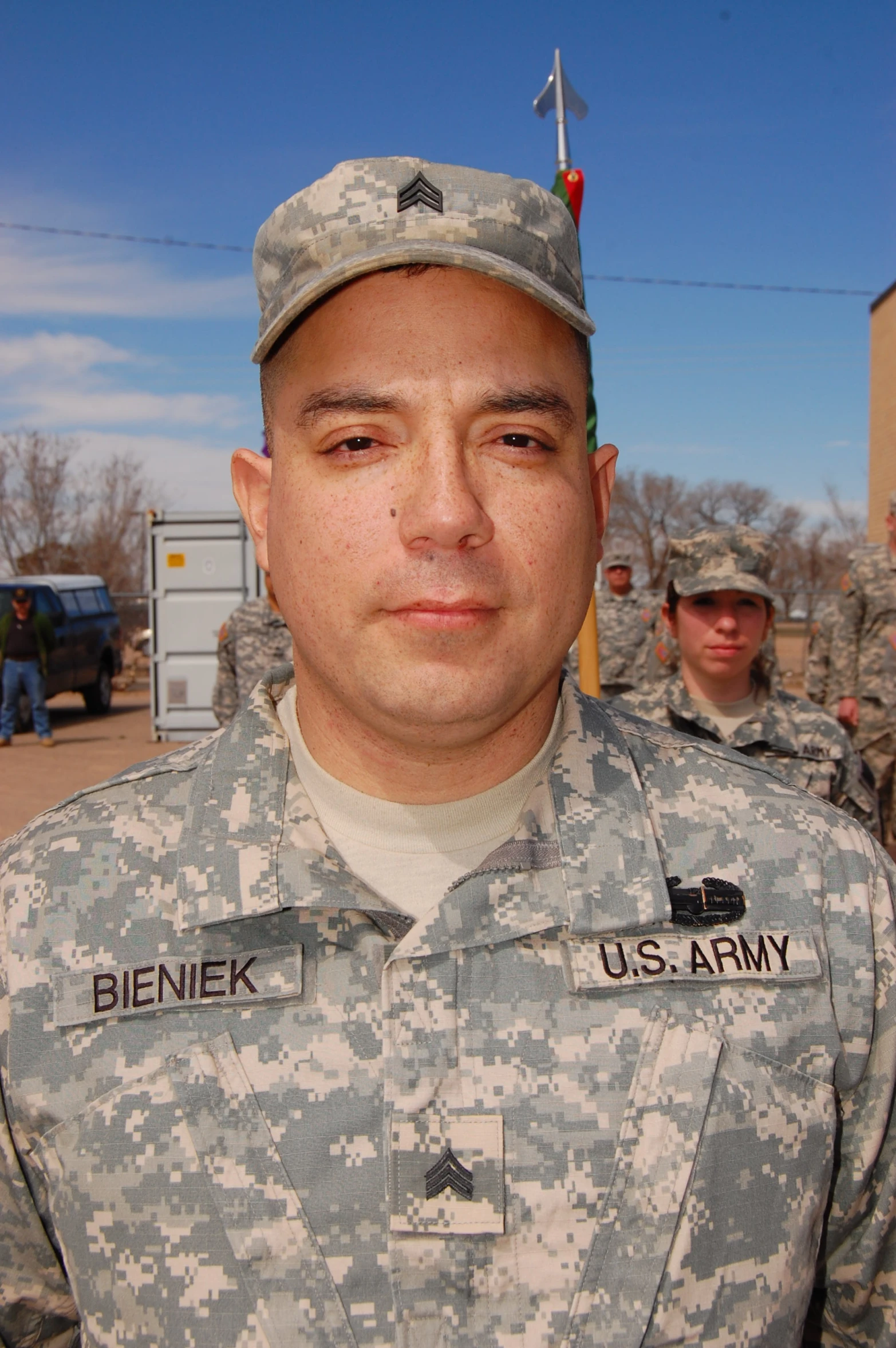 a man in a military uniform looks at the camera