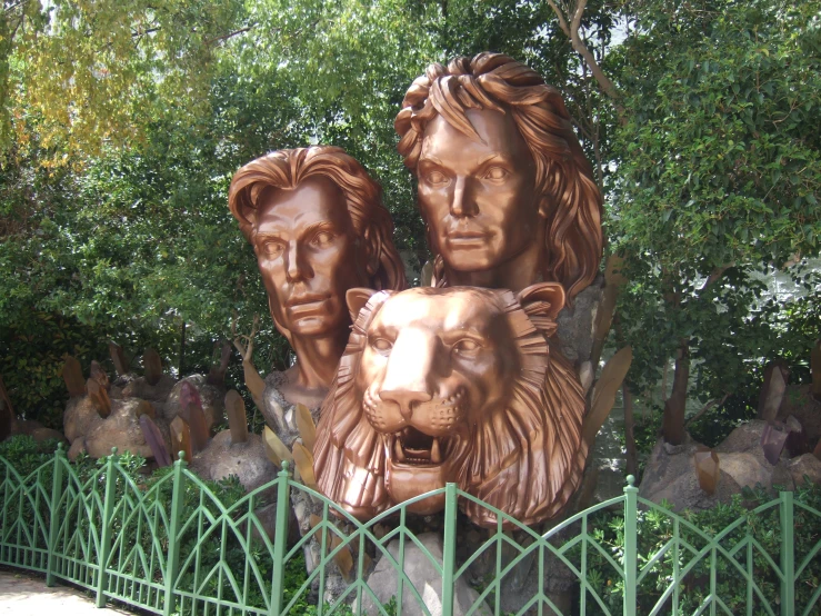 bronze statues of lions with trees in the background