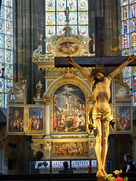 a cross with gold and a depiction of jesus christ