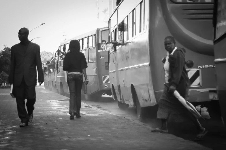 there are people walking towards an parked train