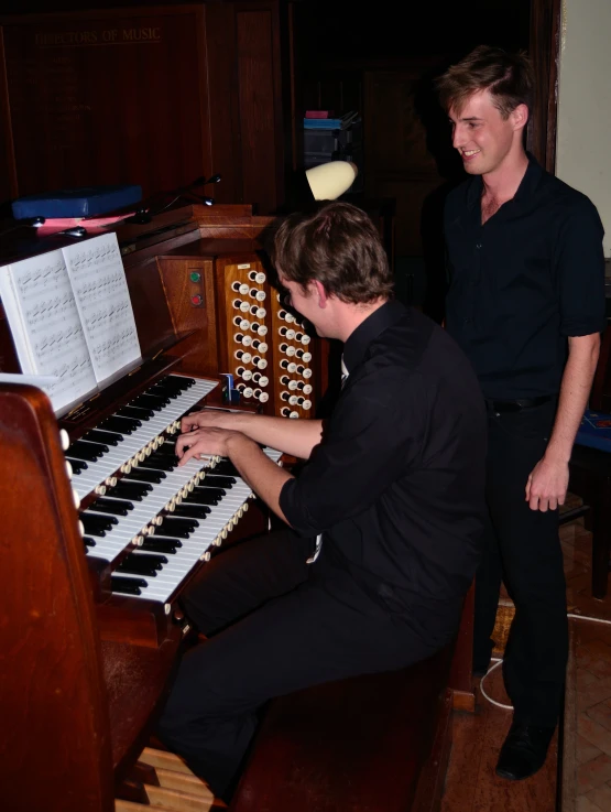 a man is playing an organ in the room