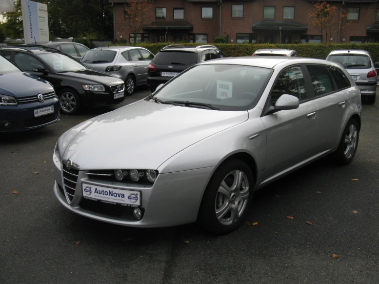 a white car with the name of the automobile in a parking lot