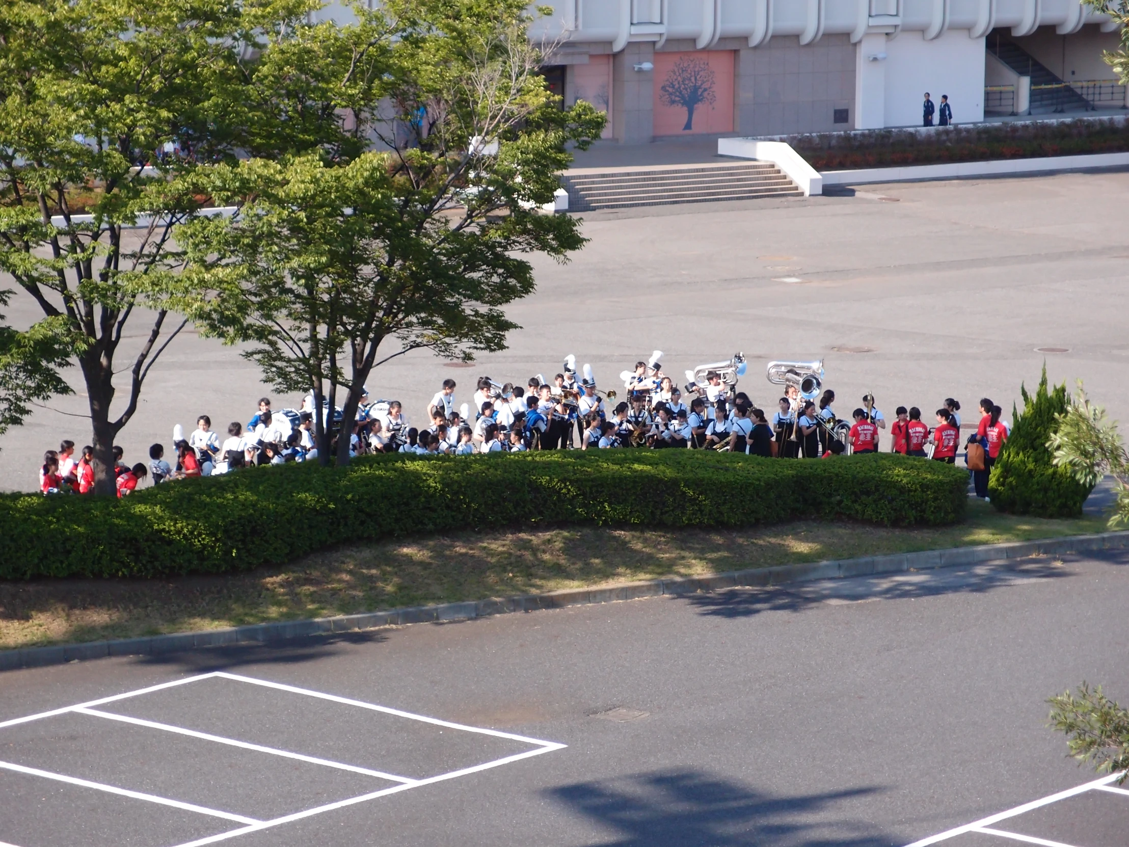 group of people standing in the parking lot