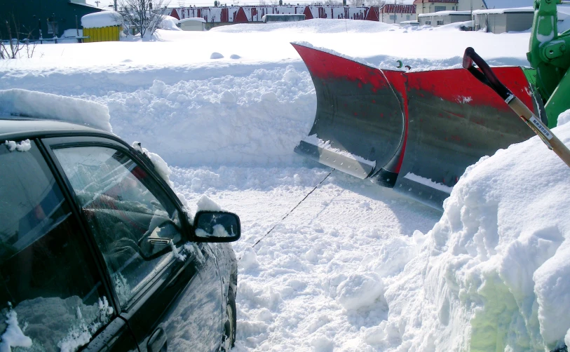 two men are clearing snow in their driveway