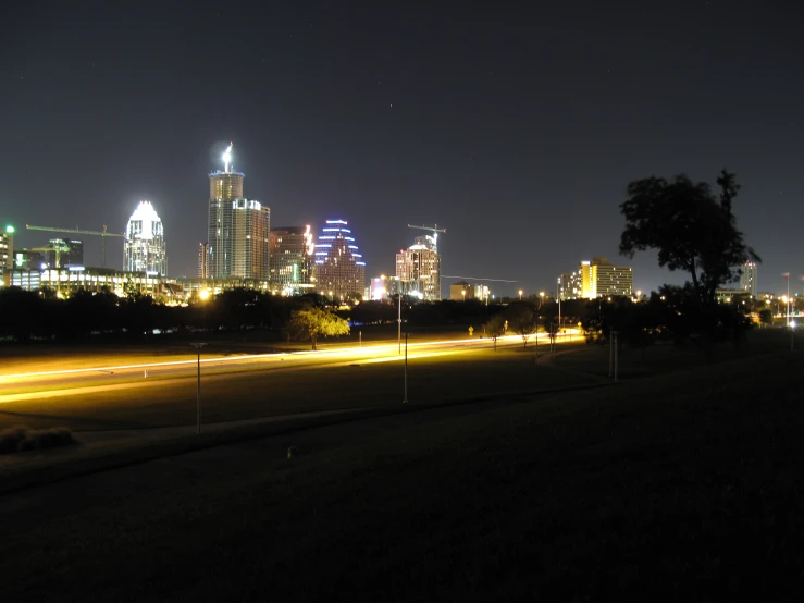 a big city that is by some bushes at night