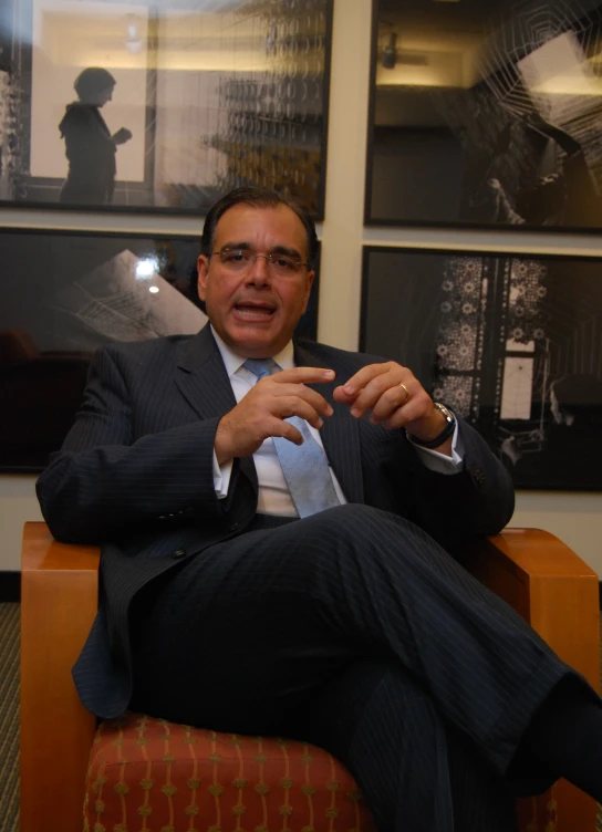 a business man in a suit sitting at a desk