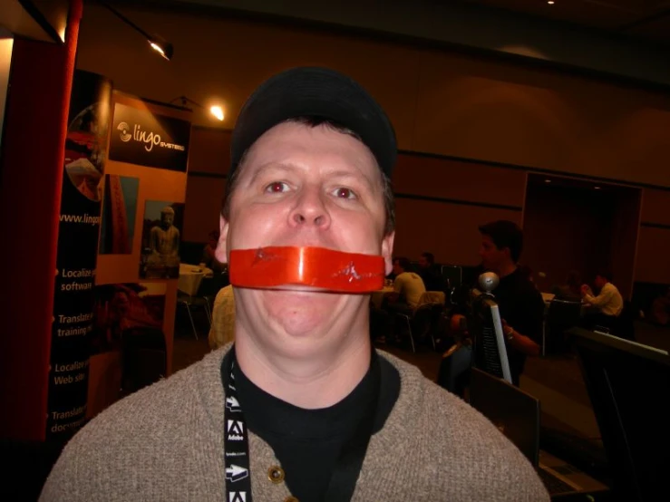 a man with a pipe in his mouth inside of an office