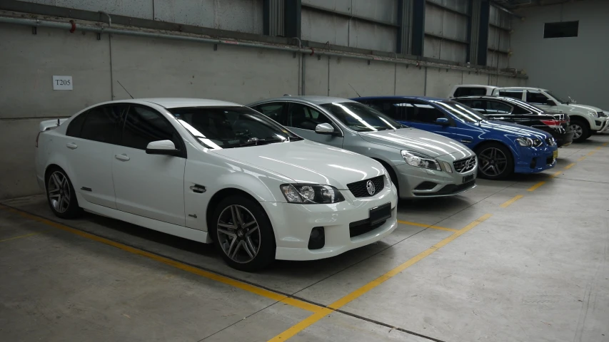 four white cars are parked in a parking space