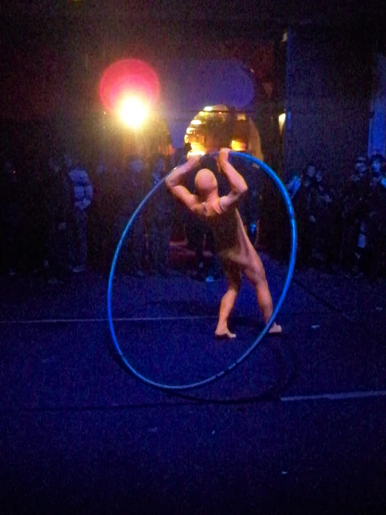 an acrobatic performer in the middle of a hoop