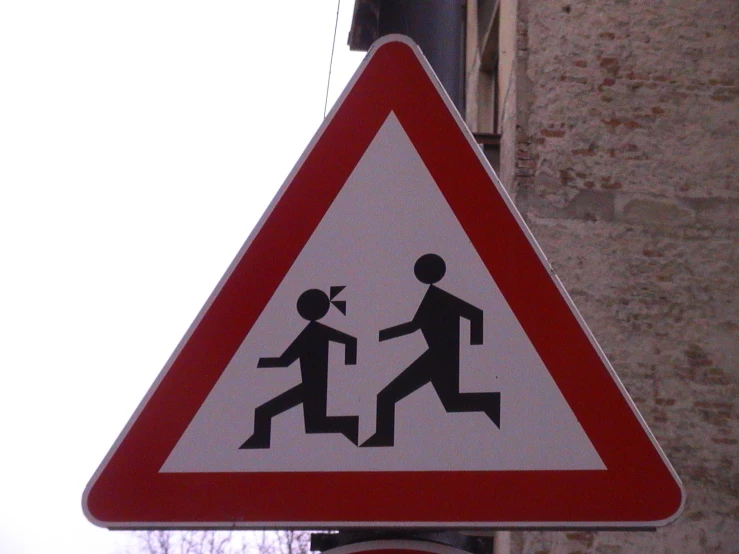 a sign shows two persons crossing on the cross walk