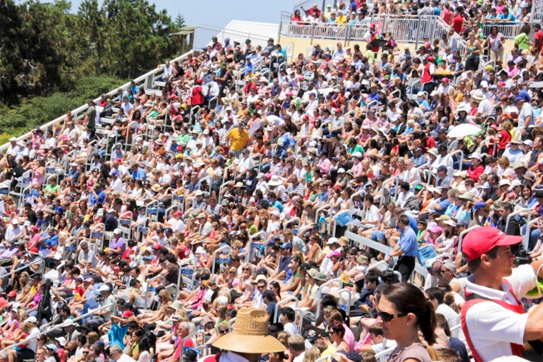 a group of people are sitting in a large stadium