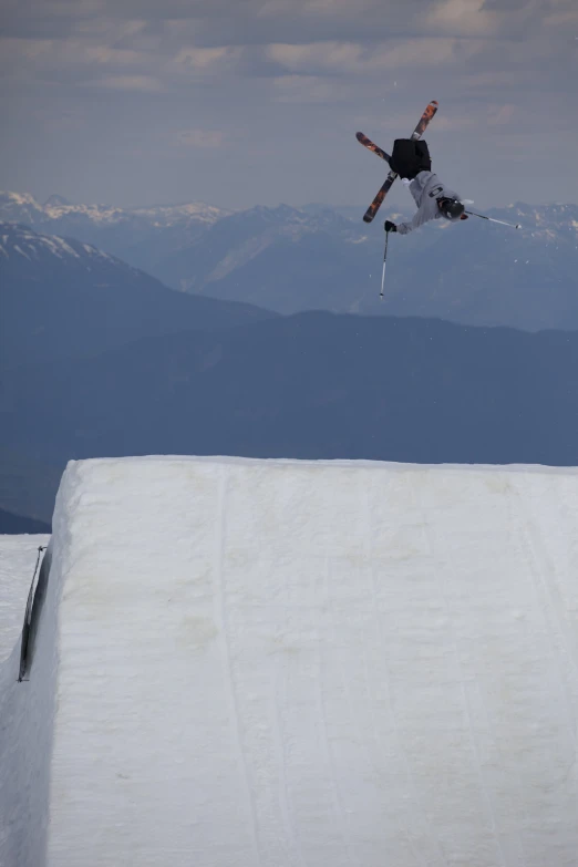 a man flying through the air while riding skis