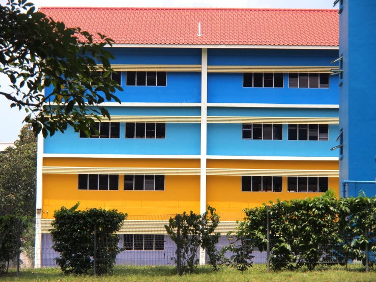 a tall building with blue and yellow exterior