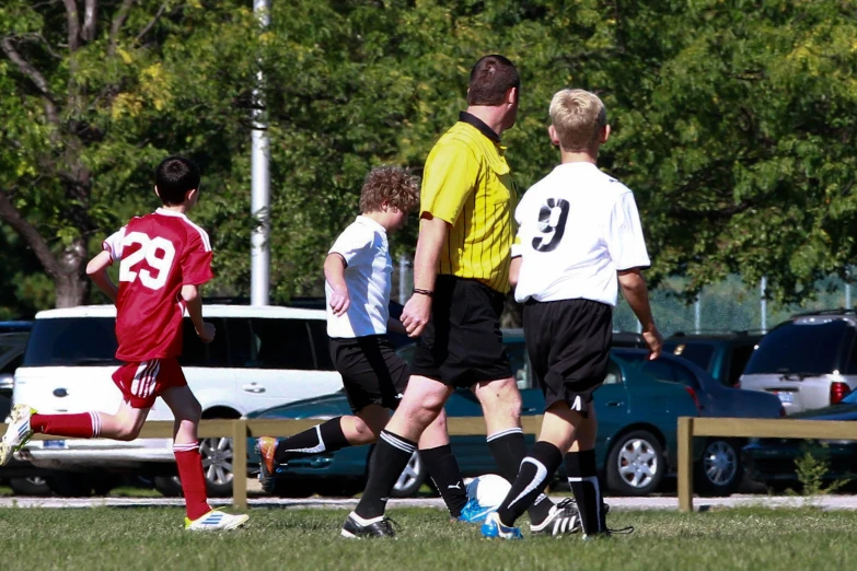 a group of young men kicking around soccer balls