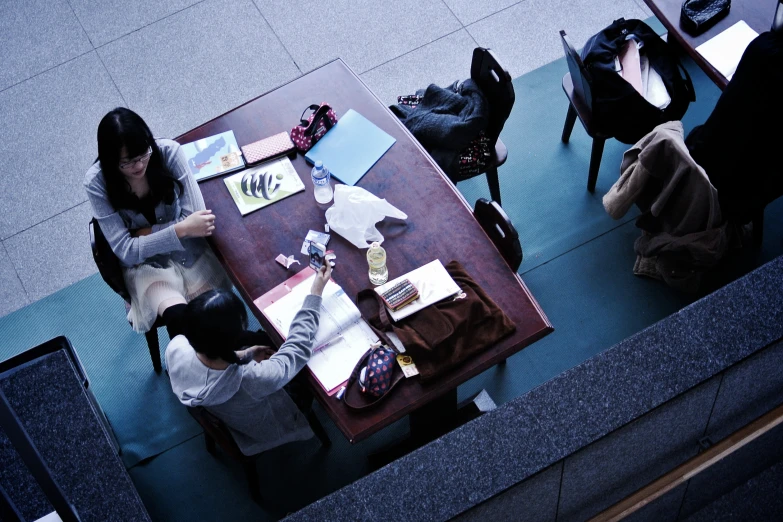 a person is sitting at a brown table