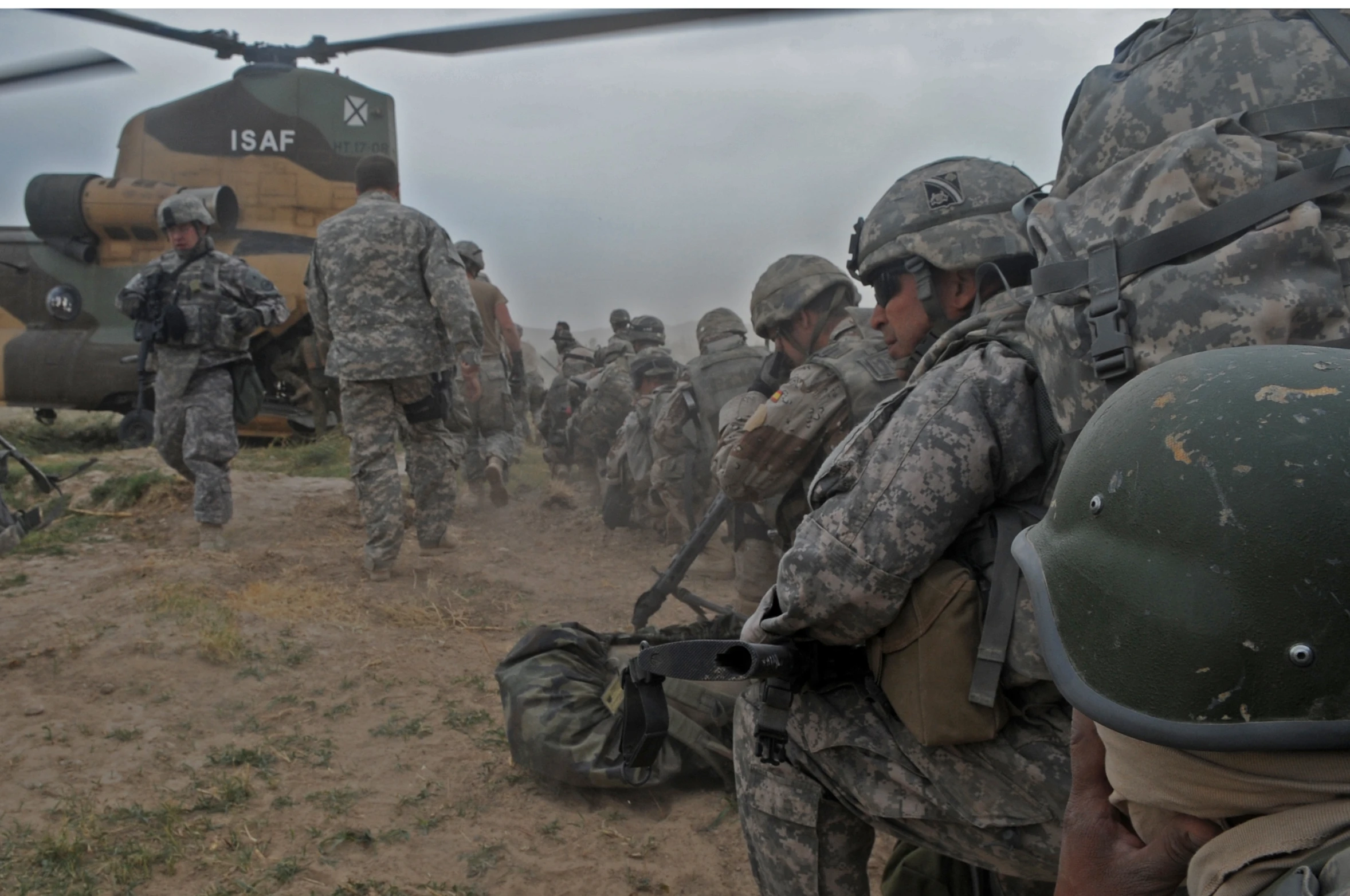 army soldiers with military equipment in the sand