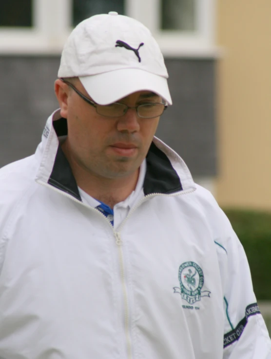 a man with a white hat and jacket on