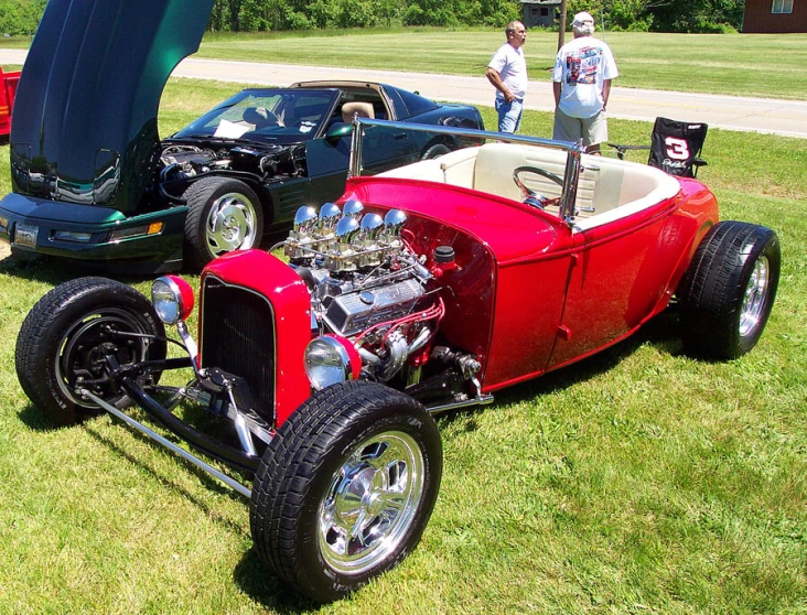 an old model ford roadster is parked in a field