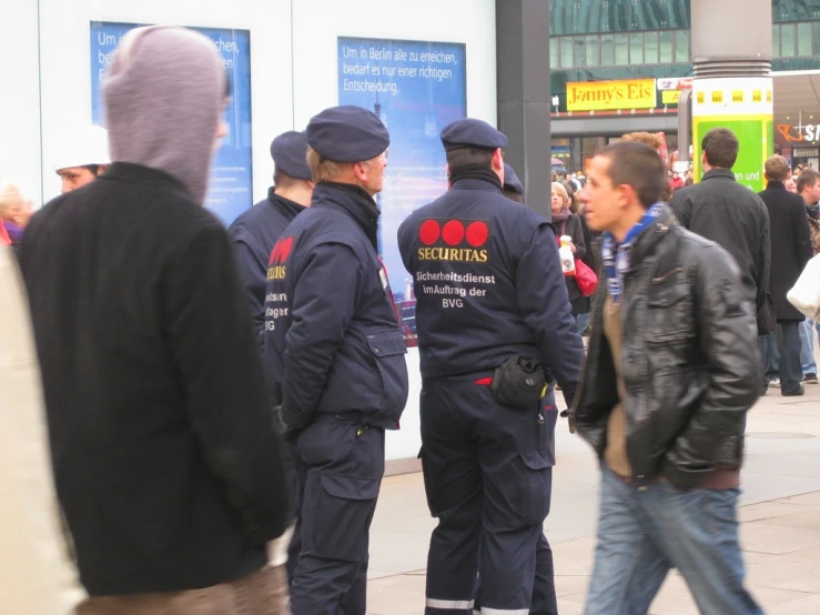 two police officers in full uniform talking to each other