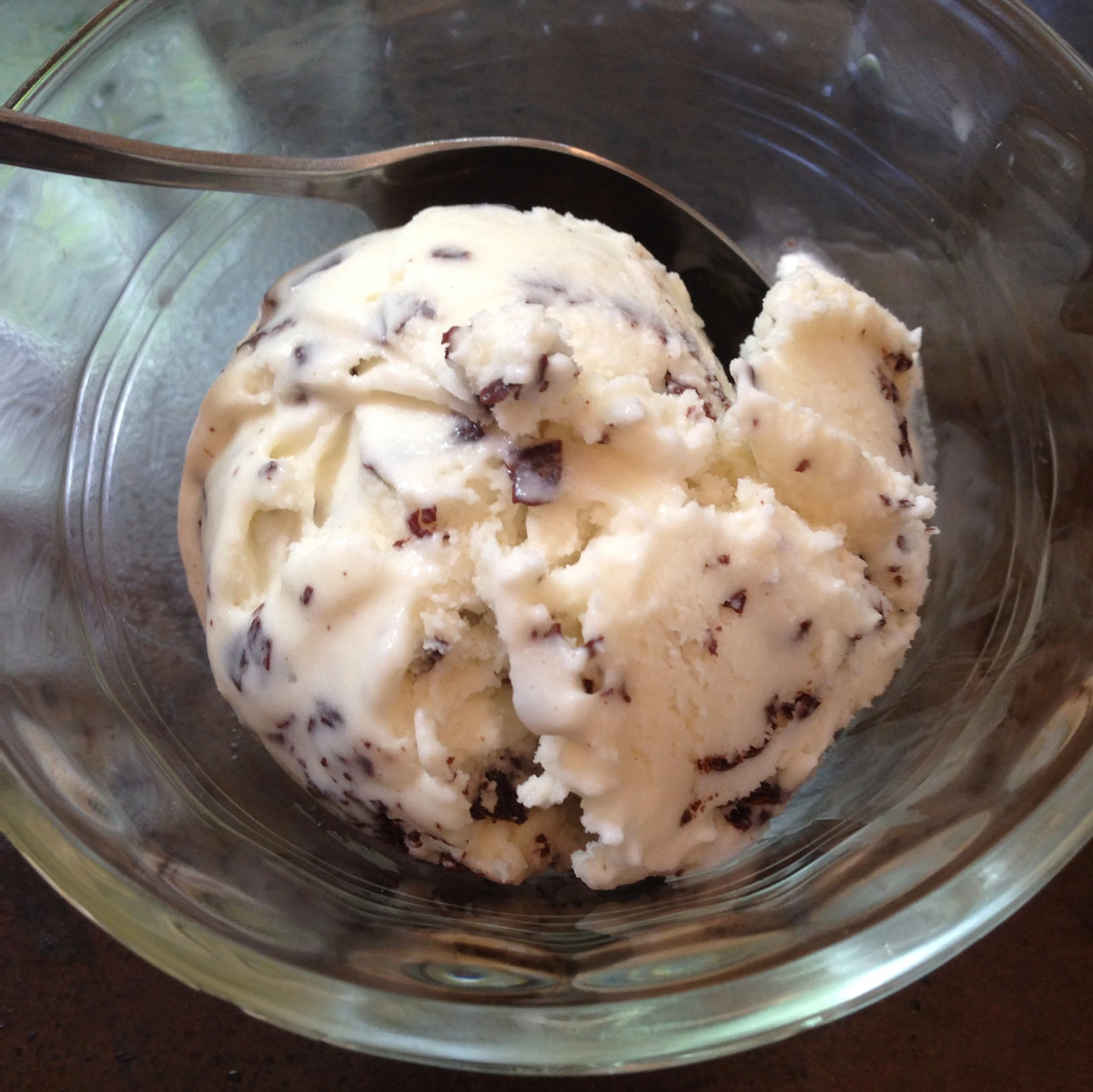 an ice cream scooper filled with a scoop of vanilla ice cream