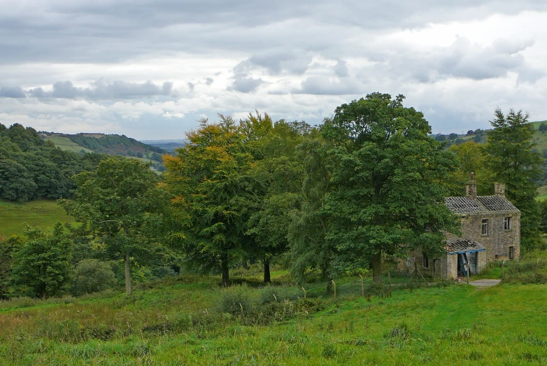 an old building stands out in a green field