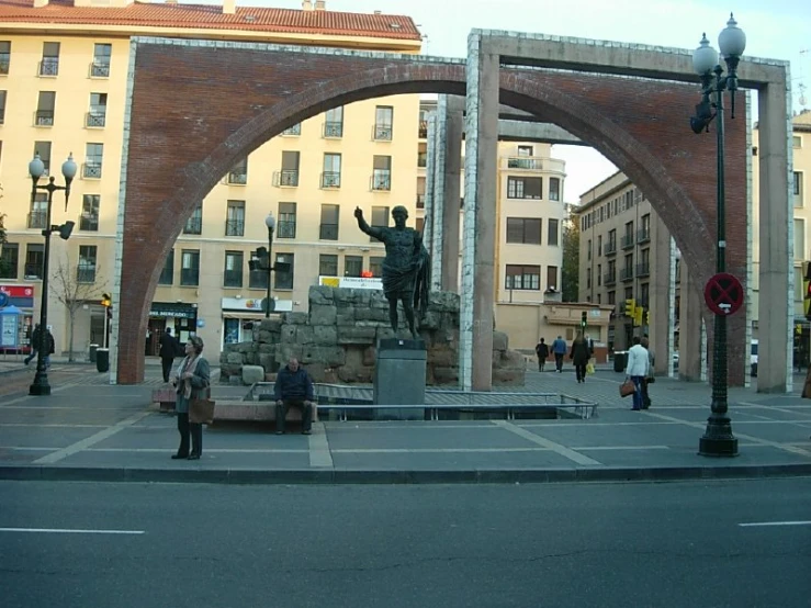 an arch is opened to reveal a bronze statue