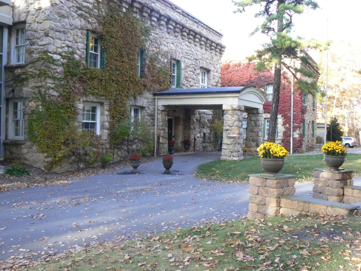 the driveway of a very large stone house