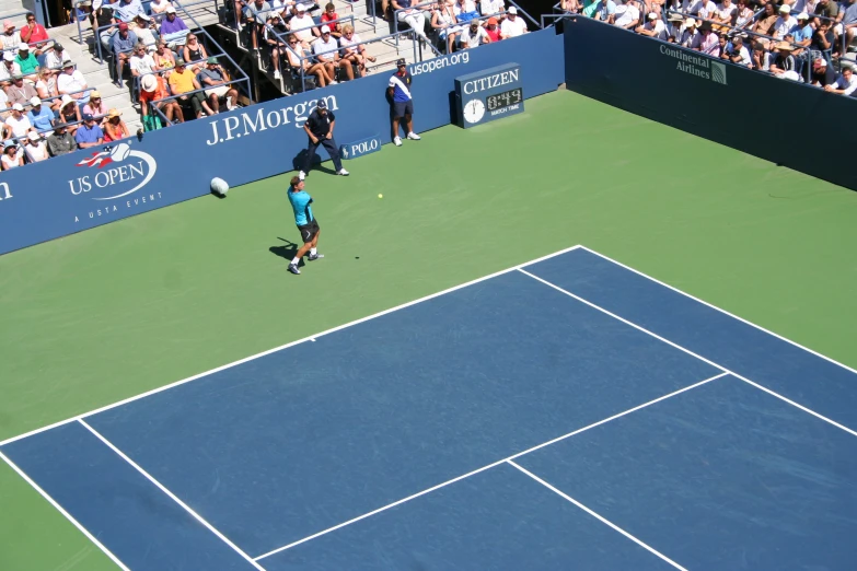 a man swinging at a tennis ball on the tennis court