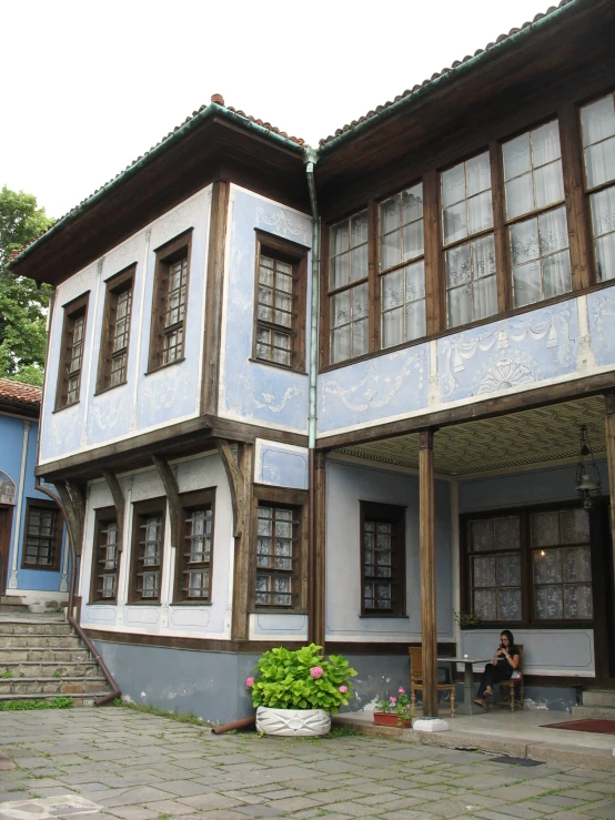 a blue and white house with wooden trim