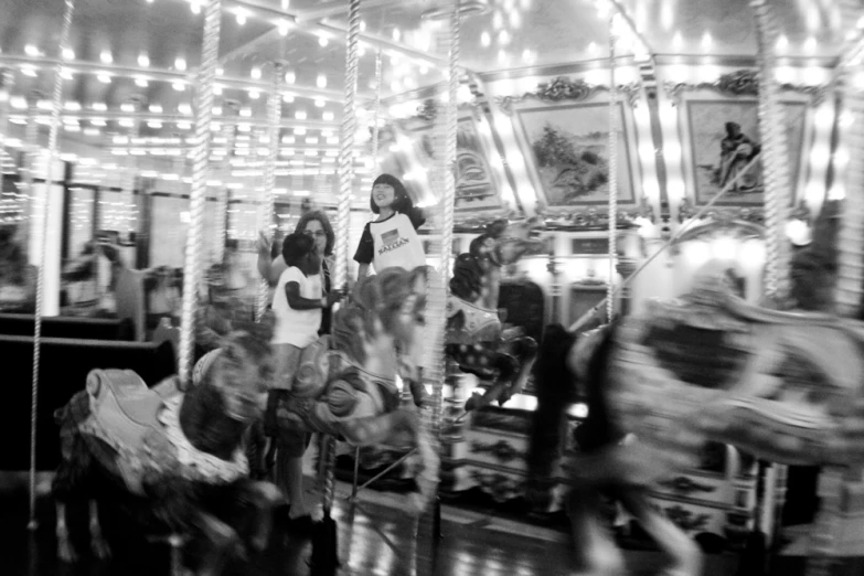 people riding on merry - go - round at night