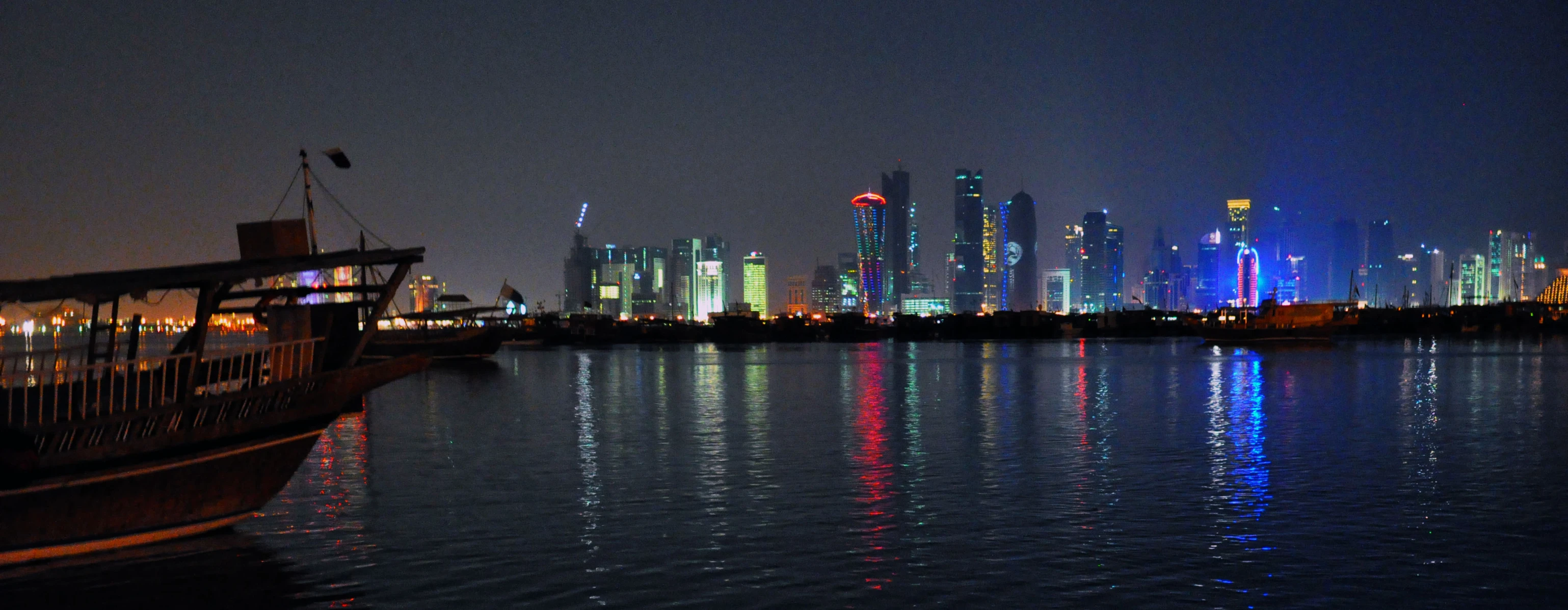 a small boat on a large body of water at night