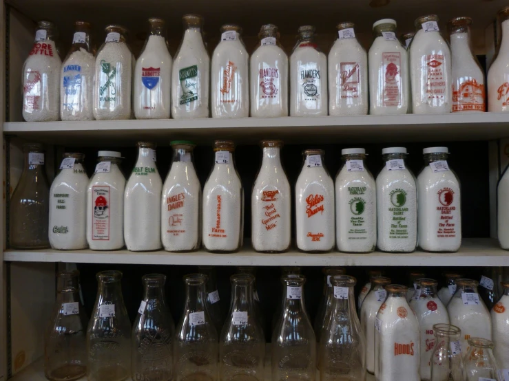 many glass bottles are displayed on shelves in a store