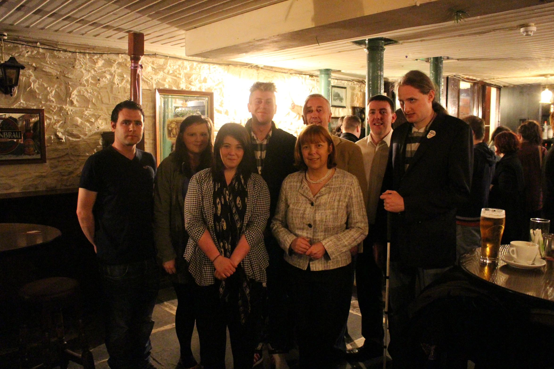 people standing together posing for a po in front of their friends