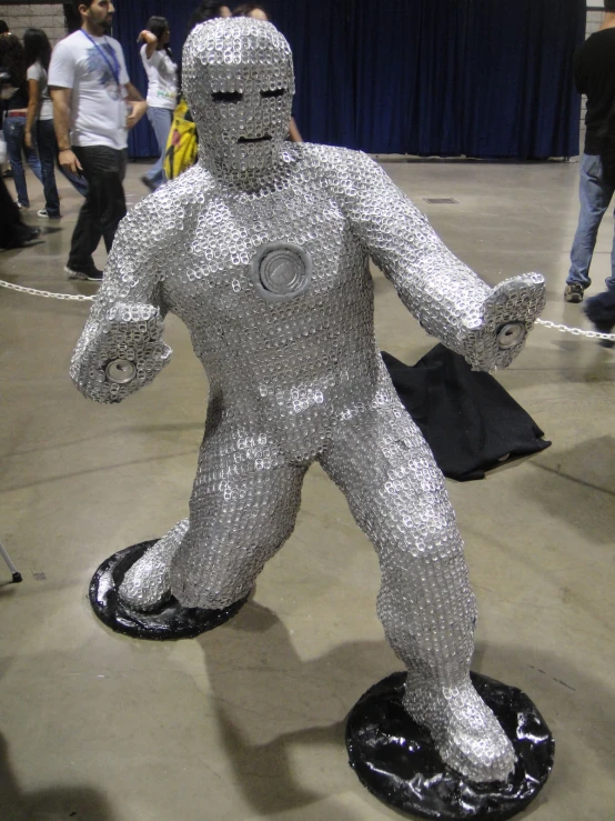 a giant silver robot standing in an exhibit