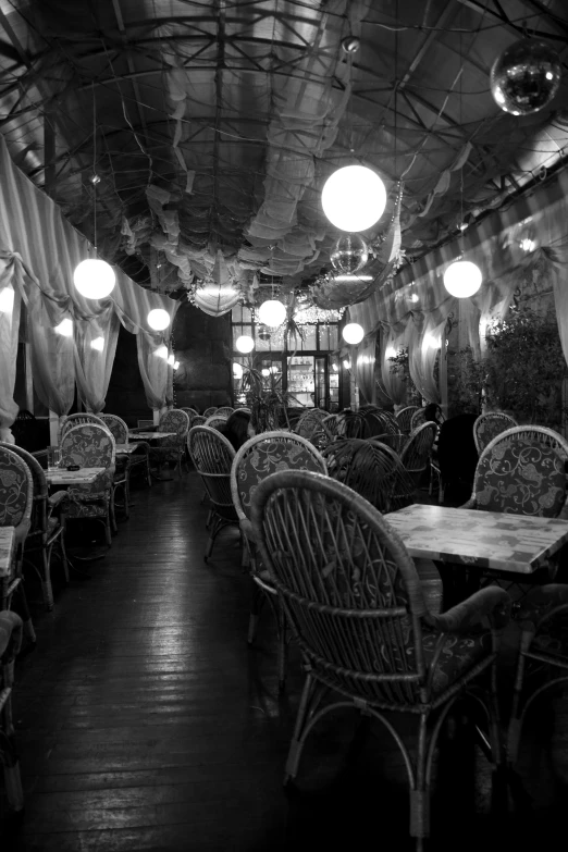 a restaurant filled with wood tables and chairs