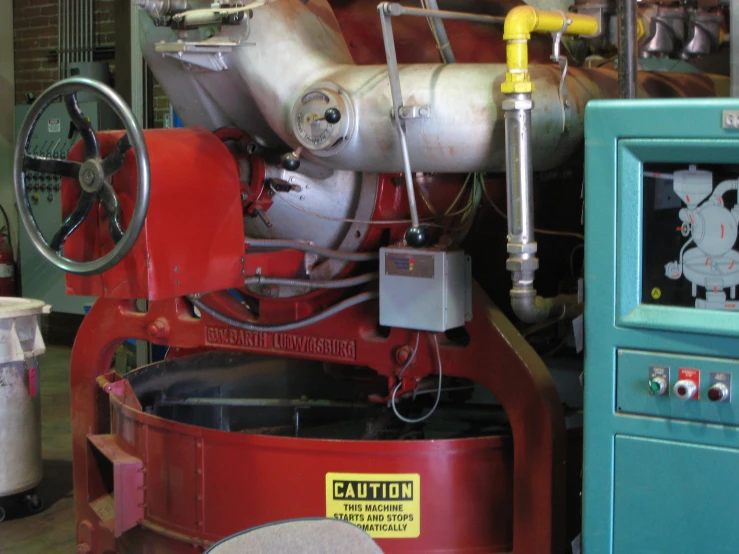 large industrial machine with several machines and a blue cabinet