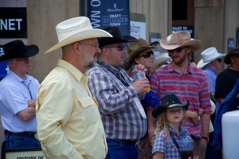 a crowd of people watching two men and one woman