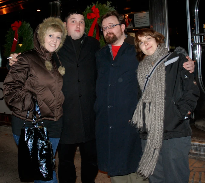 a man and two women posing for a po