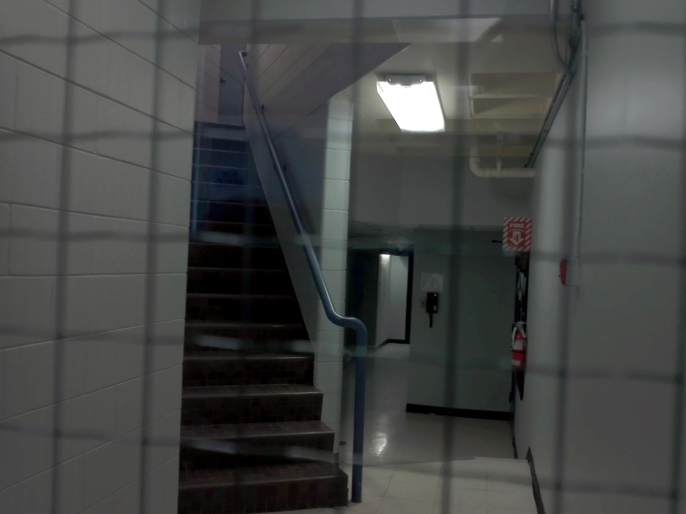 a metal staircase in a school corridor going down
