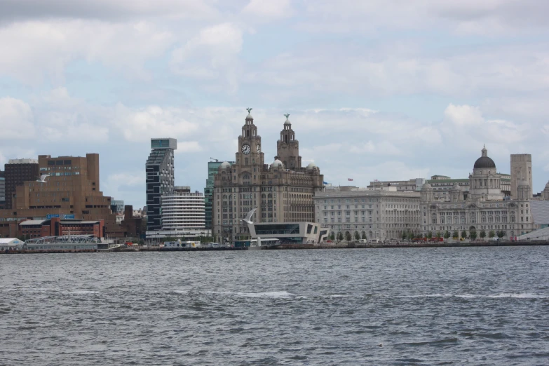 a large cityscape that has a boat on the water near it