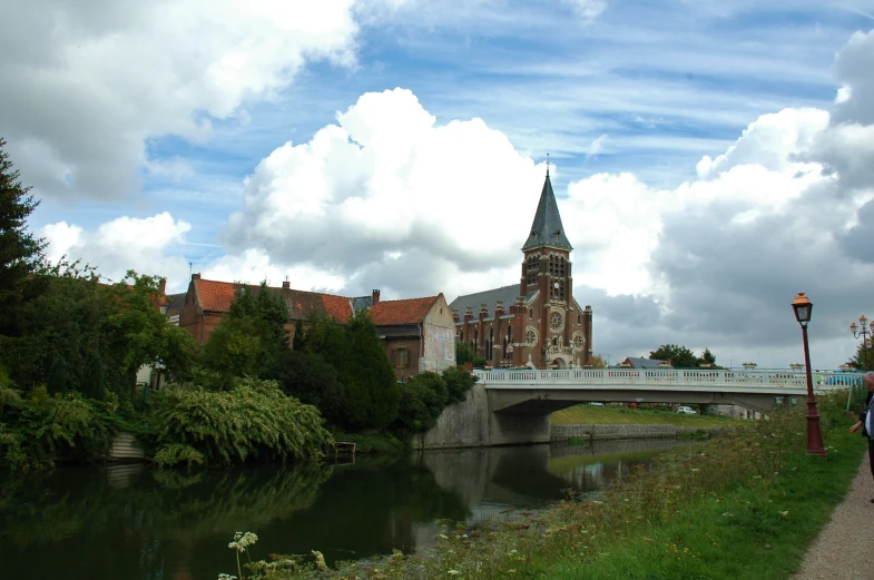 a large clock tower sitting next to a river