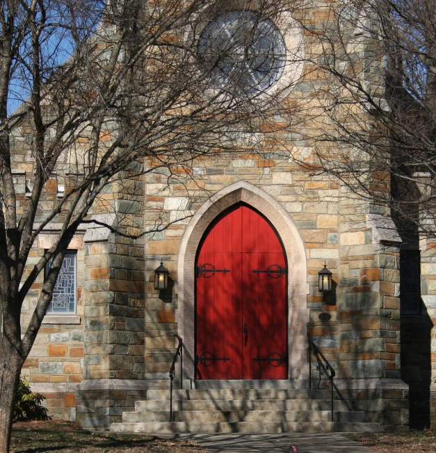 a red door and a church with an arched doorway