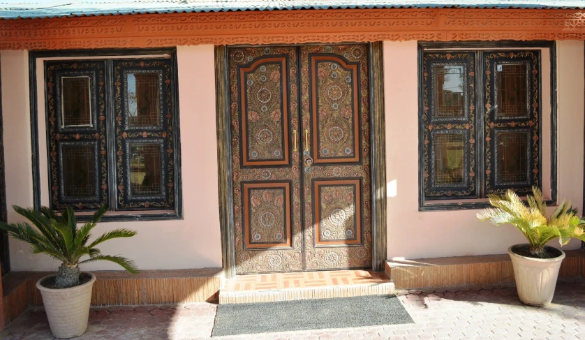 a doorway with two planters and some windows