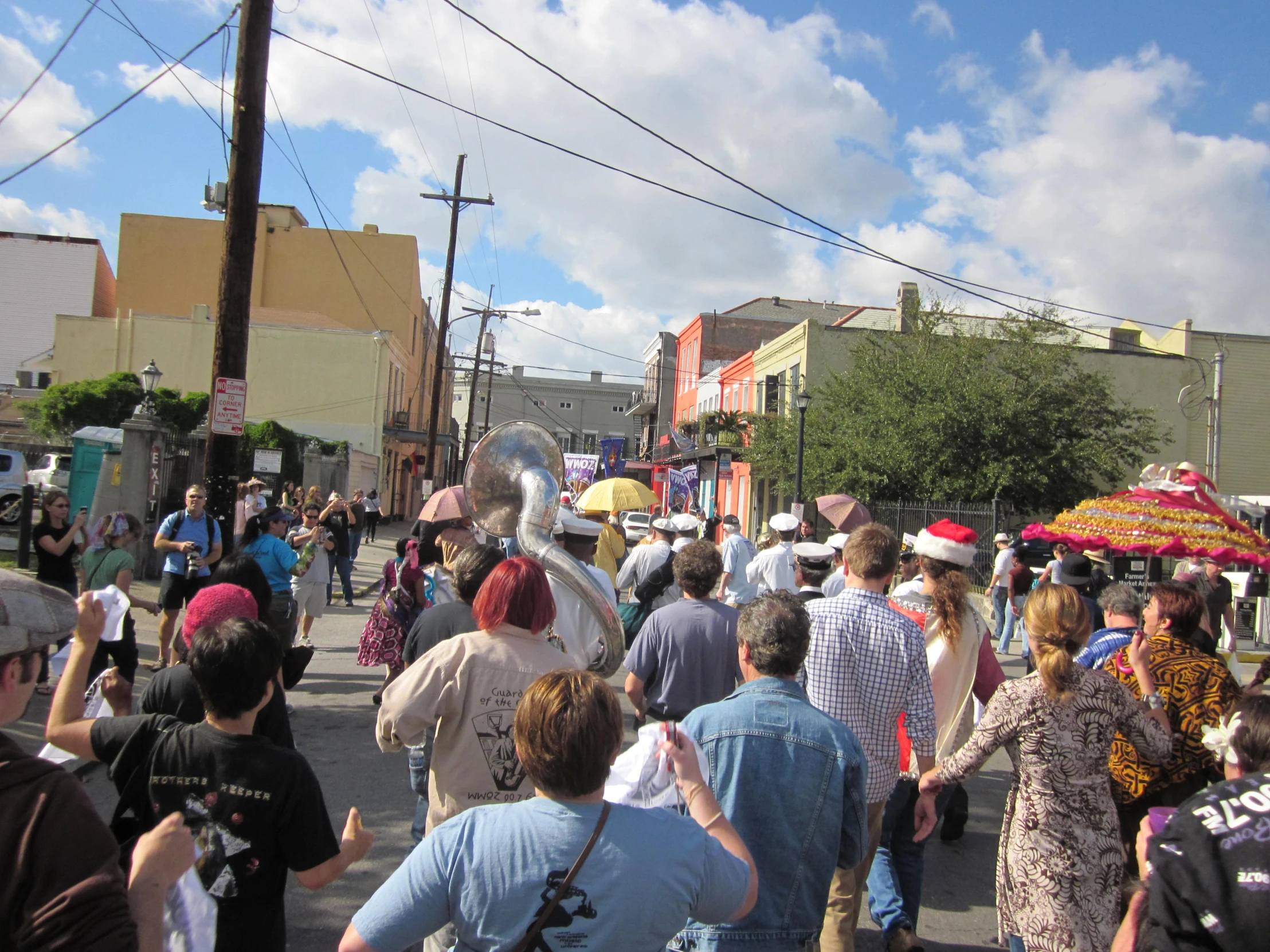 the crowd of people are walking on a sidewalk