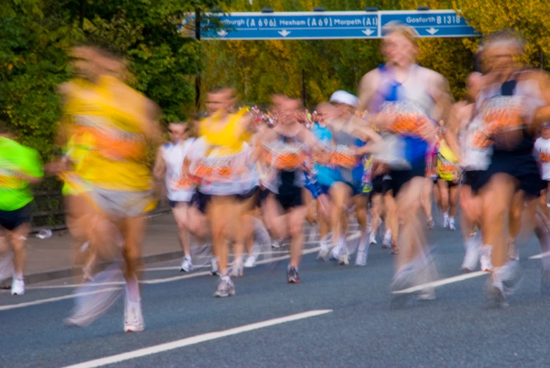 a group of people running down a street