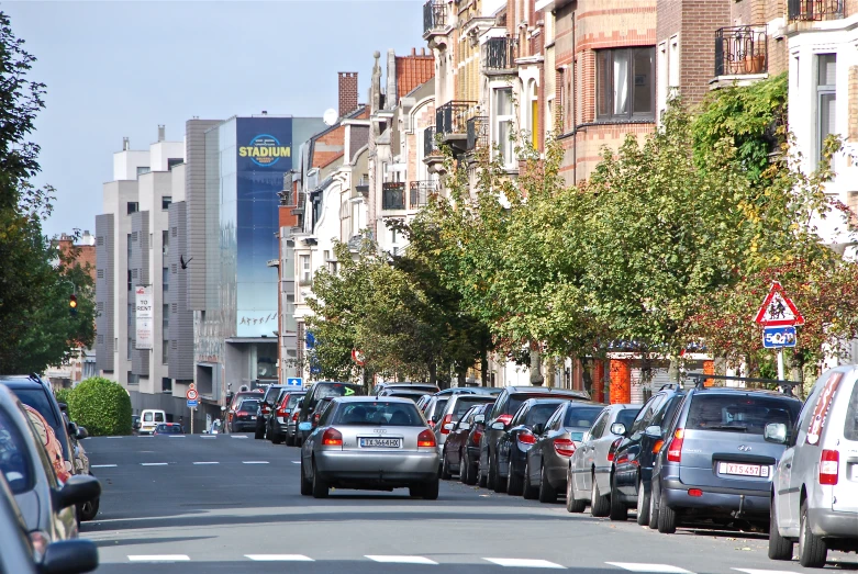 a long line of cars driving on the side of the road