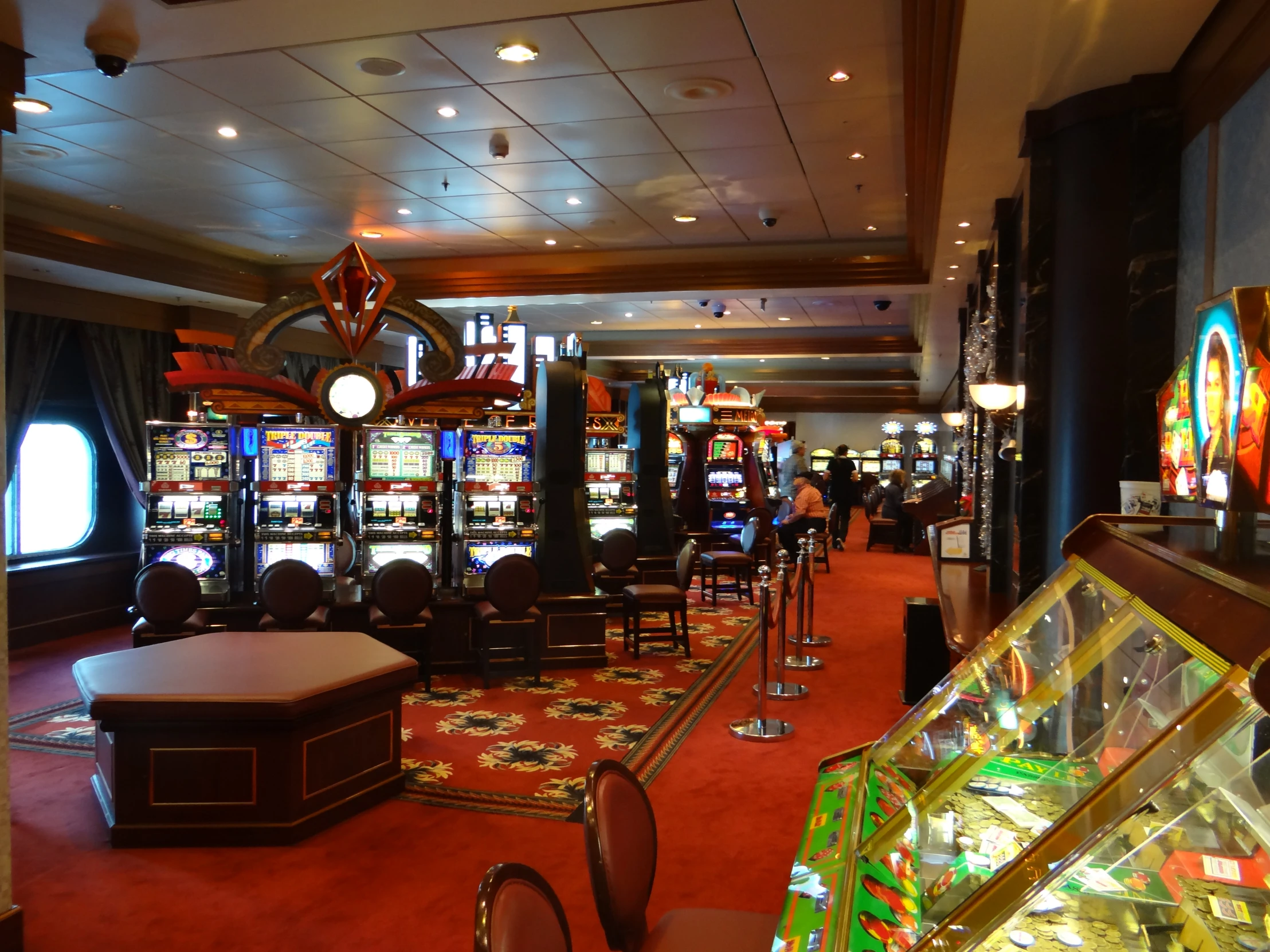 a casino room with slot machines and other games