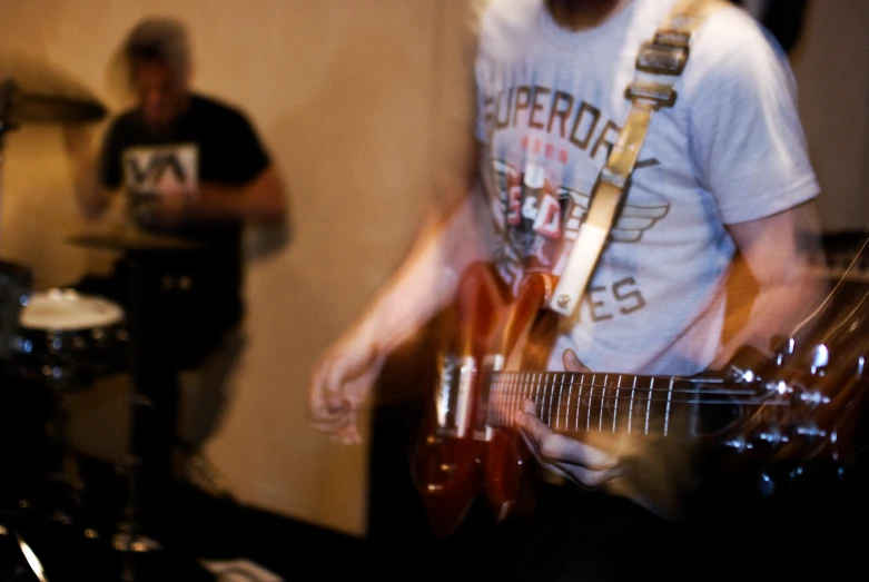 there is a musician playing an electric guitar in the studio