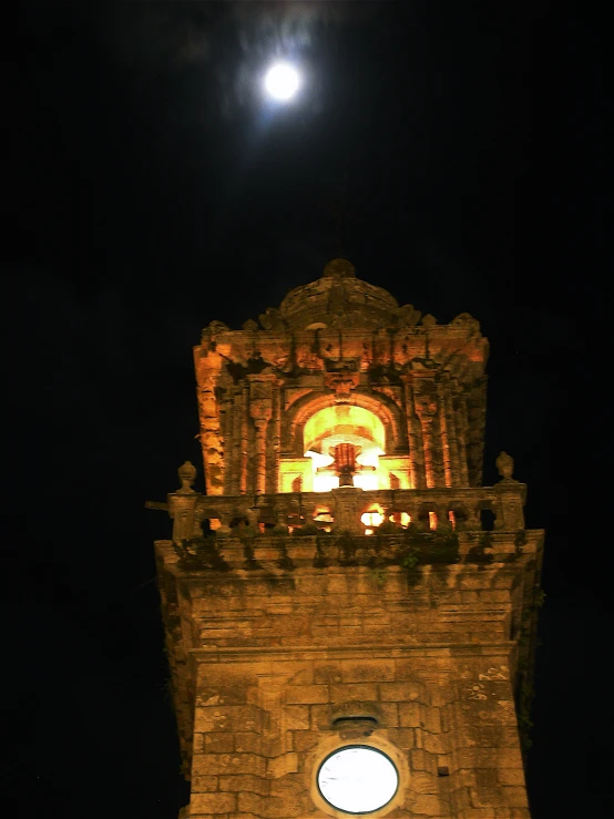 a large tower with lights inside and a light at the top