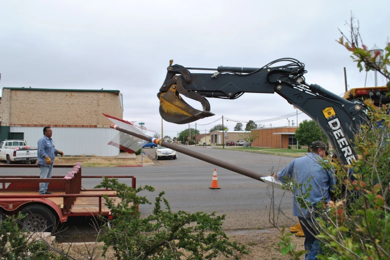 a utility truck has a crane attached to the back end